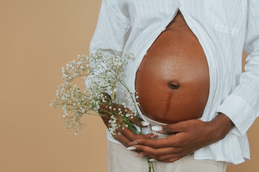 Pregnant woman holding flowers